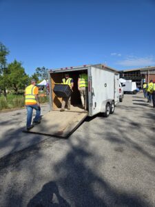 Electrical contractor using a pallet jack to load storm recovery gear into a trailer